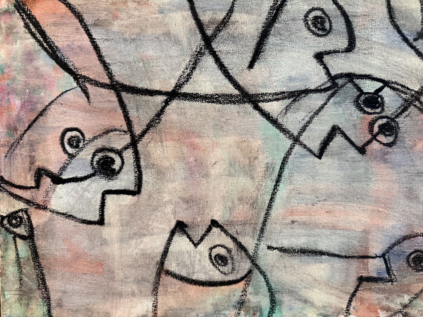 A child's cubist-style painting of abstract faces with charcoal outlines
