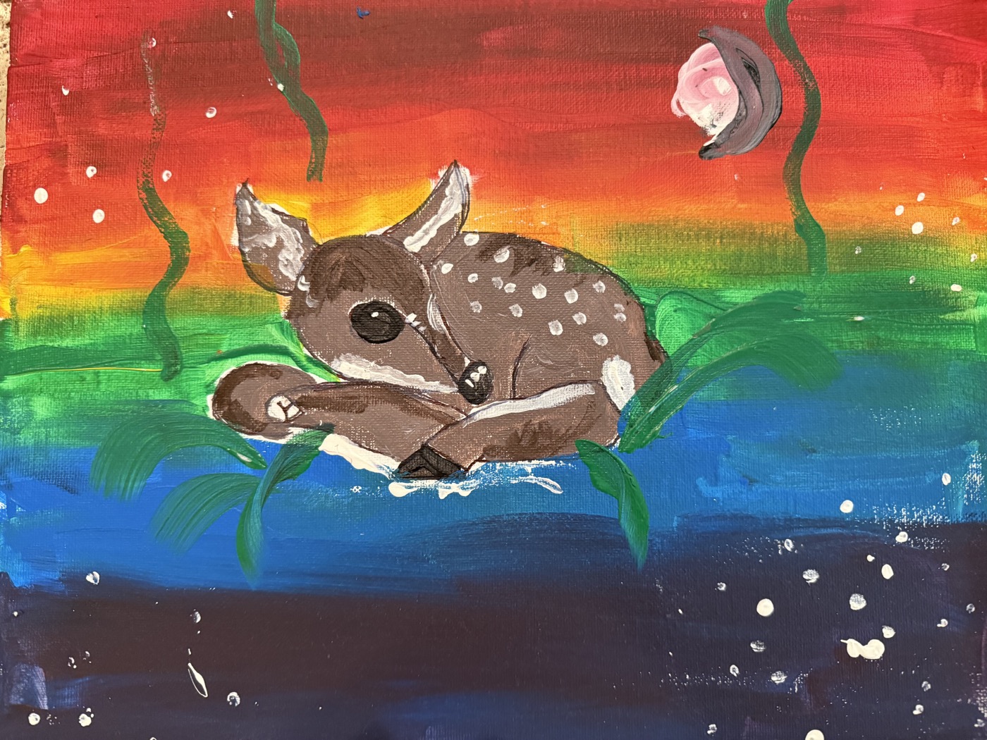 A child's acrylic painting of a spotted fawn against a rainbow sky
